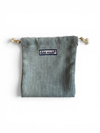 Labö Made sage green corduroy drawstring pouch with a branded woven patch, perfect for organising small essentials.