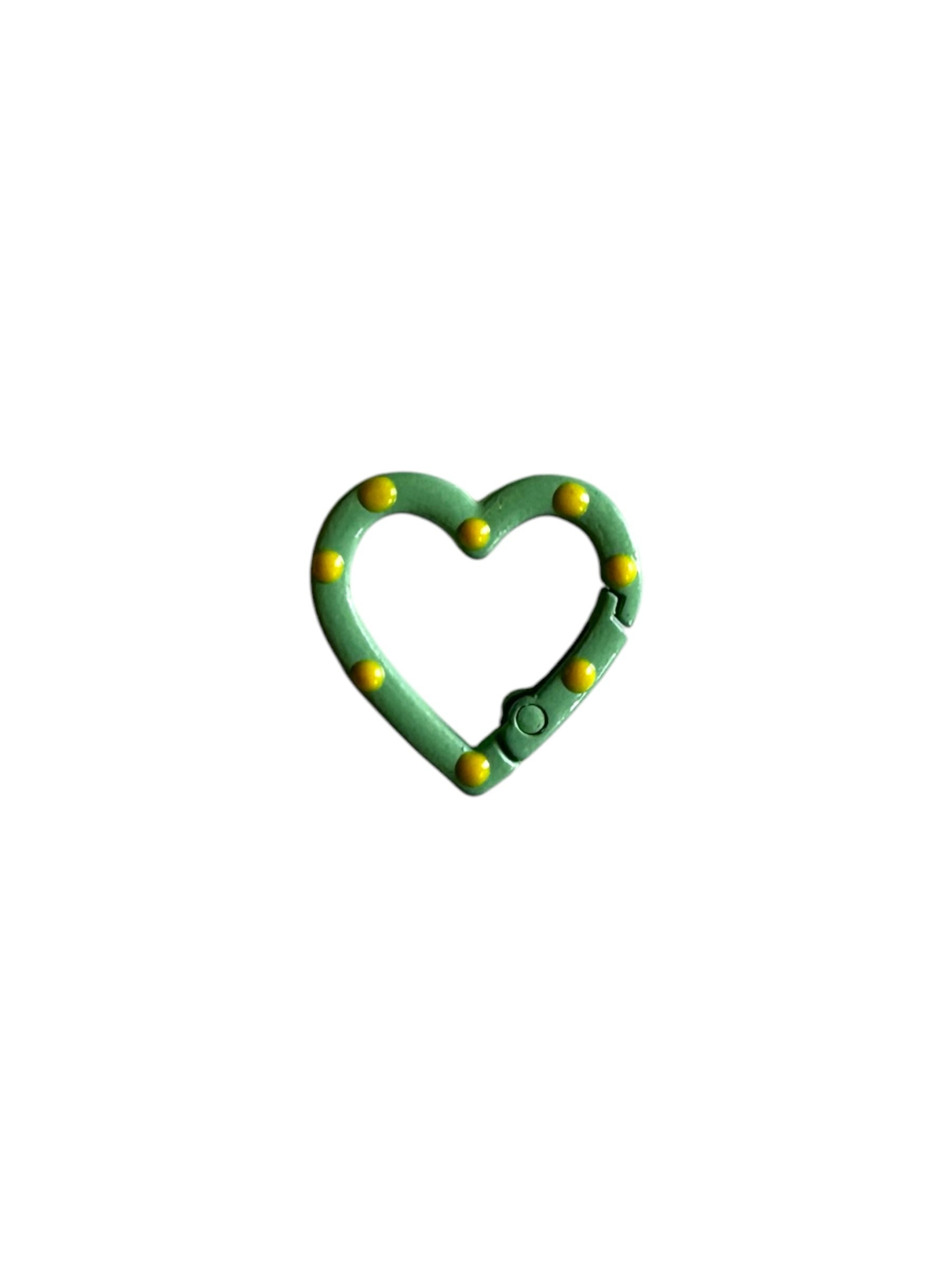 Labö Made heart-shaped carabiner clip in mint green with yellow stud detailing and a spring-loaded gate.